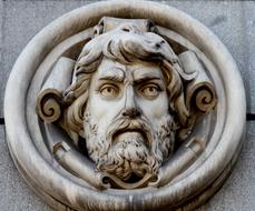 Beautiful carving with the portrait of the bearded man, on the Bank of Spain, in Madrid, Spain