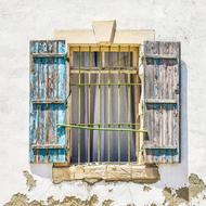 dilapidated window on the old facade