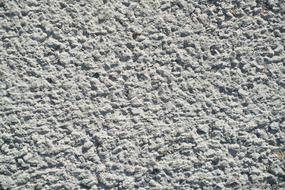 Close-up of the texture of the grey stone wall, in light