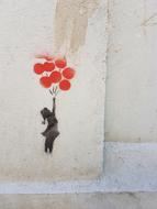 girl with red balloons on graffiti