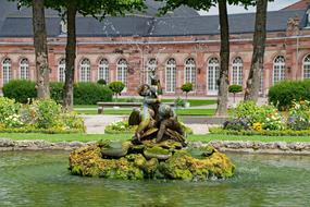 Beautiful and colorful garden with the plants, water and architecture, near the castle in Schwetzingen, Germany