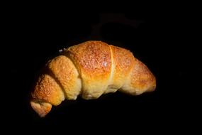 sweet croissant on a black background