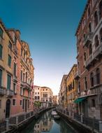 boat on a canal among multi-storey buildings