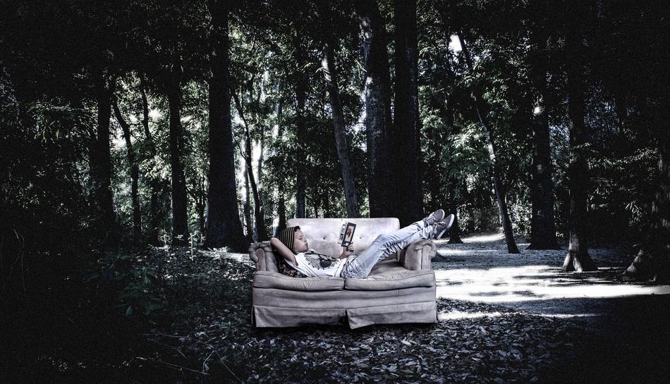 girl resting on the couch in the woods