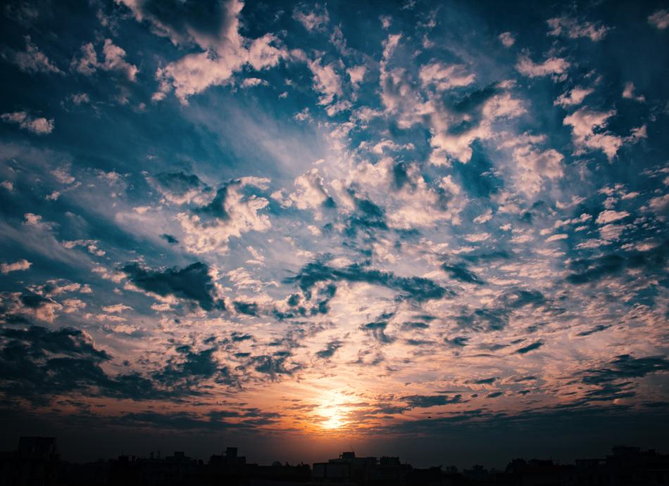 cloudy sky with the sun in the distance