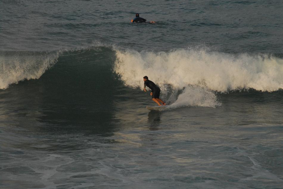 surfboarder on board at foamy wave