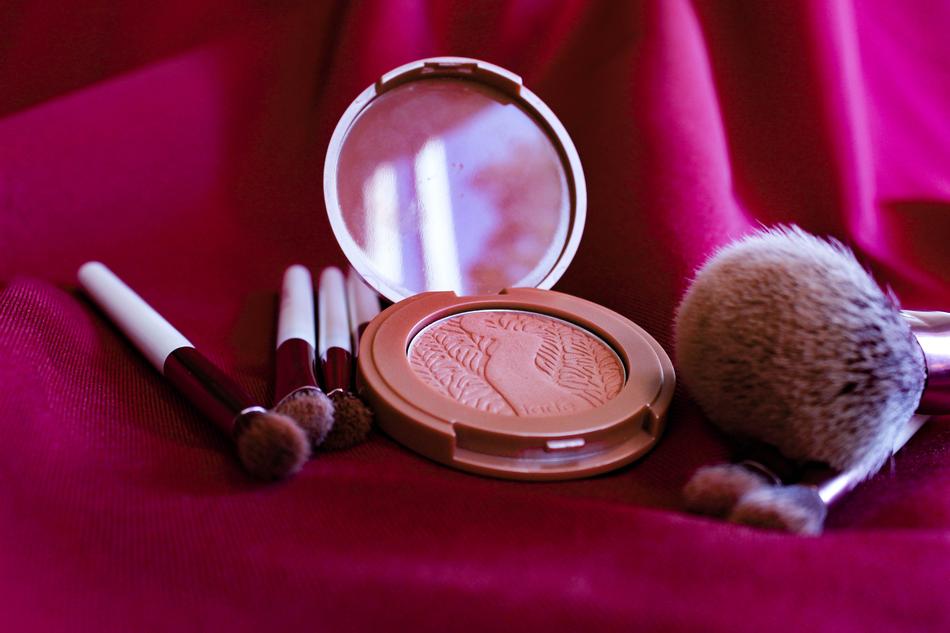 Makeup products on a pink background