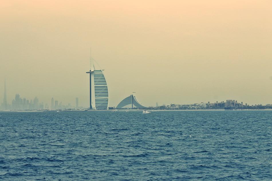 distant view from the water of Burj Al Arab at dusk