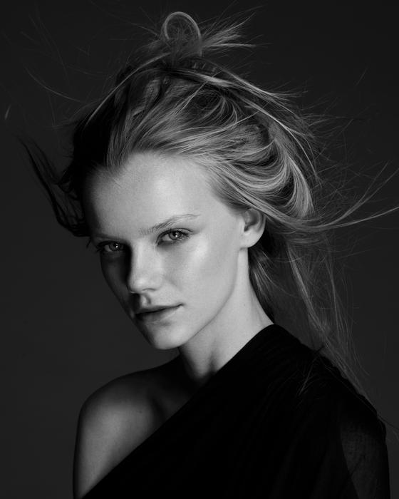 Black and white portrait of the beautiful girl with long hair and make-up