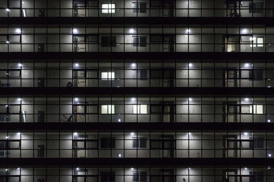 Shiny apartments, with the windows and lights inside, among the darkness