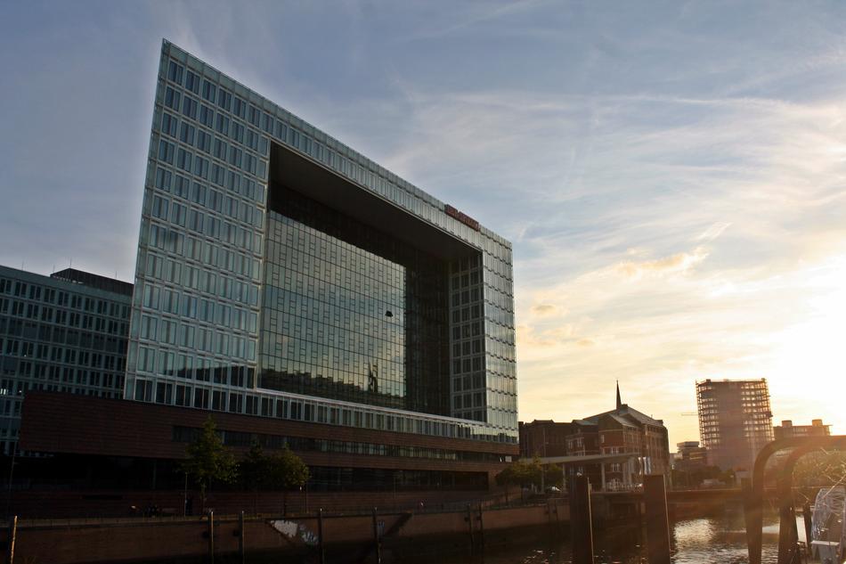 mirrored building in the harbor at dusk