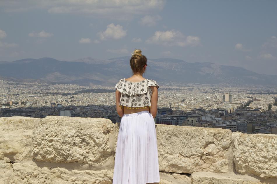 Back view of the girl in dress near beautiful Athens, Greece