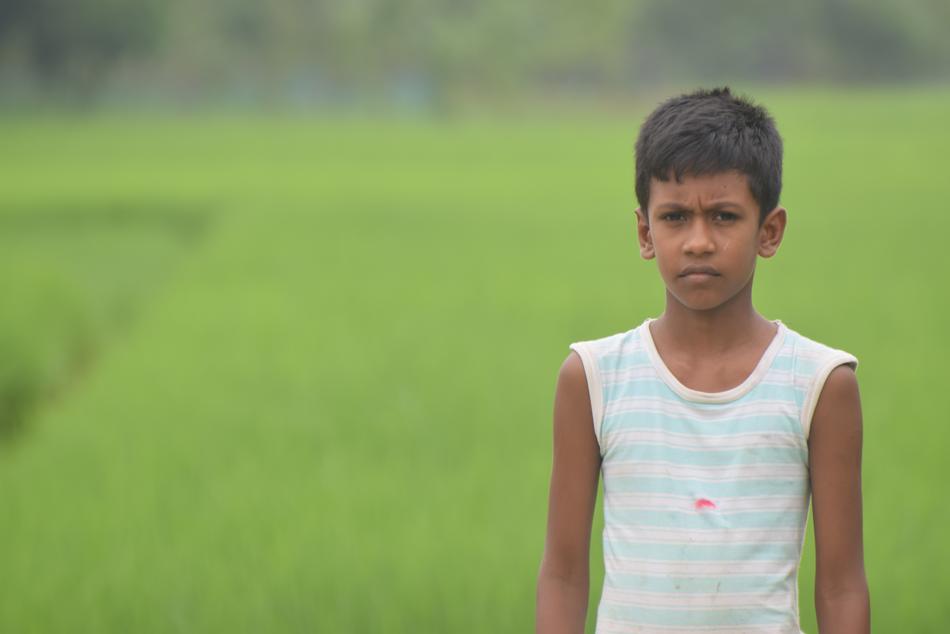 boy in bangladesh on green blurred background