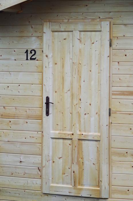 Number '12' on the colorful, wooden building of the different shades, near the door