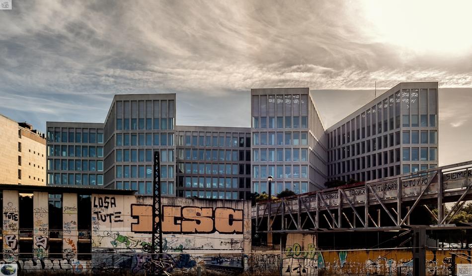 Colorful buildings with the graffities, in Seville, Spain, under the clouds