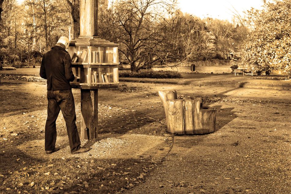 man with books in the park in monochrome