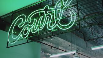 green neon sign on the building