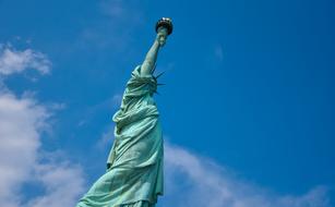 Statue Of Liberty against the background of a bright blue sky