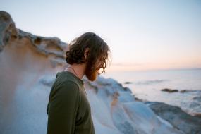 photo of man with beard on coast