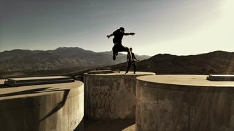 jumping over concrete architecture in the mountains