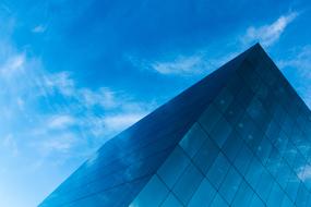 blue glass building against the sky