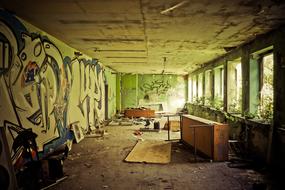 Old and colorful, abandoned building with the graffities, in sunlight through the windows