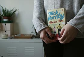 book in the hands of a girl in the house