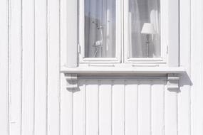 window with white wooden building facade