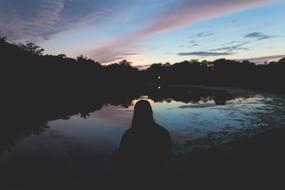 Girl Sitting sunset lake