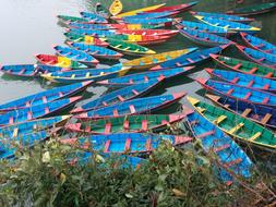 colored beautiful boats at the pier in the lake