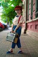 boy with retro radio on city street on blurred background