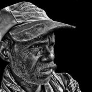 monochrome photo of a homeless man in a cap