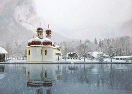 church by the lake in the snow