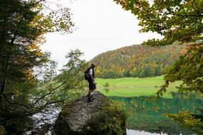 man on a rock by the lake
