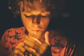Portrait of a guy, lighting a cigarette