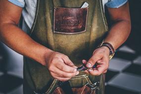 hands of a man in an apron