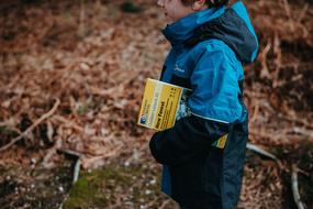 child with a book in the forest