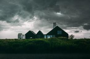 houses in the village against the background of evening clouds