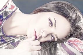 Portrait of the beautiful, laying woman, in light