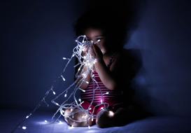 Child, playing with the beautiful, white lighting