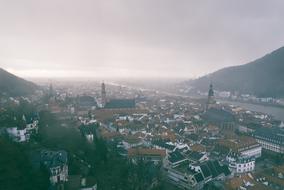 Beautiful and colorful landscape of the city, among the mountains, under the sky with clouds