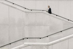 a man climbing a marble staircase