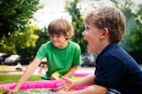 Kids, playing with the colorful toys, among the colorful plants