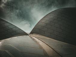 Roof of the building with shapes, under the dark sky