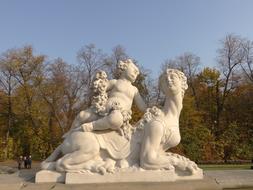 sculpture of a putto and a sphinx in a park in Poland