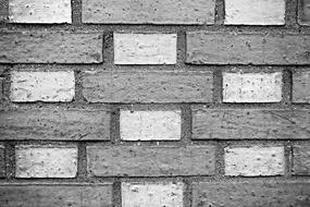 Close-up of the grey and white brick wall of different shades