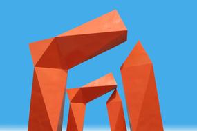 Construction with orange shapes in Monterrey, Mexico, under the blue sky