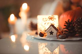 Christmas decorations, figurines, pine cones, candles on the table