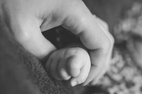 Hands of Mother and newborn baby