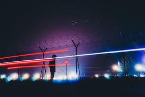 lights and barbed wire fence at Night Sky